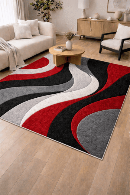 A luxury hand-tufted wool rug featuring a bold 3D wave pattern in red, black, and grey colors placed in a modern living room setting.